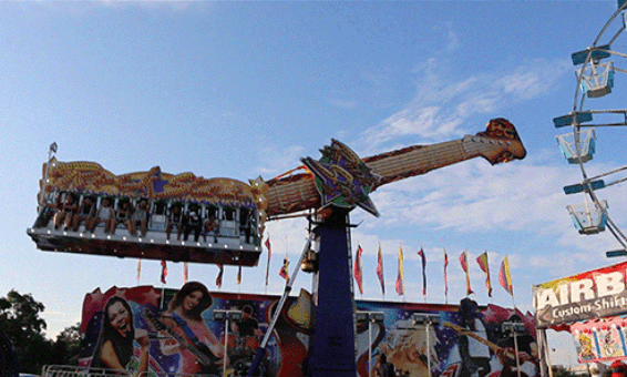 A carnival ride with people riding on it.